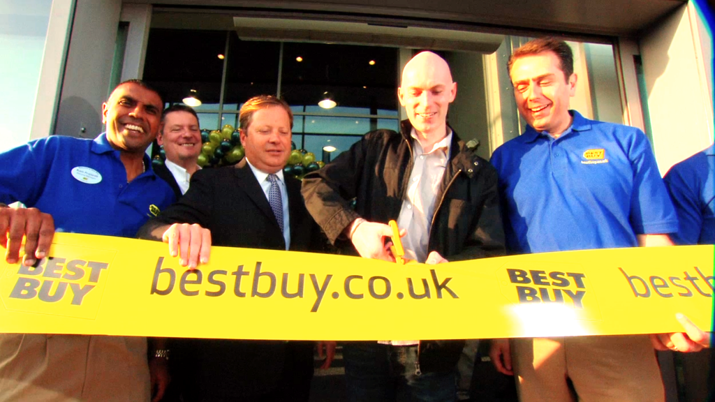 Best Buy men cutting ribbon